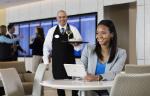 Image of employee serving food and beverage inside the United Club