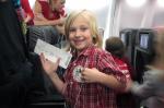 Child holding boarding pass and smiling