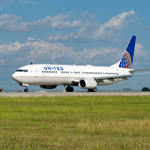 Image of United Boeing 737 taxiing down runway 