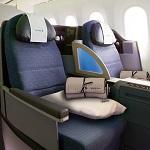 Premium upright business class seat with Sax Fifth Ave pillow and bedding