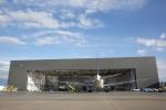 Image of a hangar and an aircraft outside it