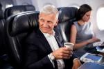 illy CEO Andrea Illy seated next to female passenger