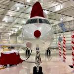 Airplane with red Rudolph nose and a Santa hat