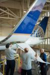 Image of 3 United technicians installing a new Split Scimitar Winglet on a Boeing 737-800