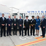 Image of United staff members in front of signs announcing use of sustainable biofuels
