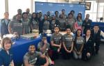 United employees and Chicago Urban League students with cake to celebrate the sendoff